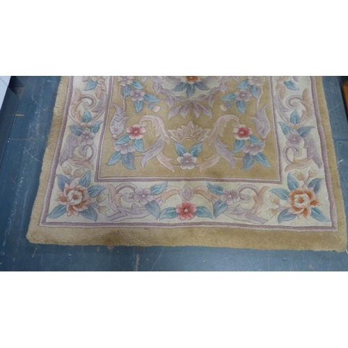 415 - Chinese-style rug on beige ground.