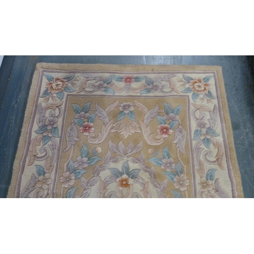 415 - Chinese-style rug on beige ground.