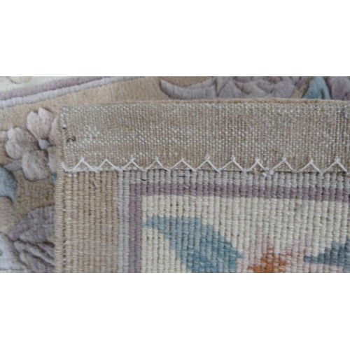 415 - Chinese-style rug on beige ground.