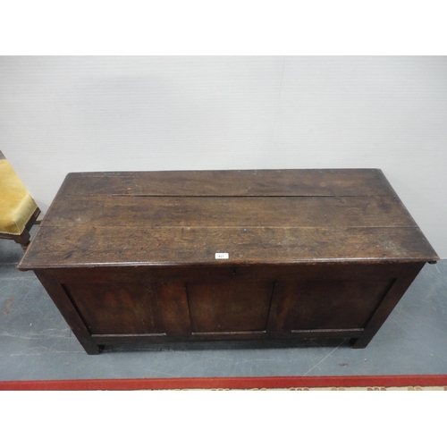 421 - 19th century oak coffer with hinged top enclosing a pine candle box, three-panel front, iron lock, o... 