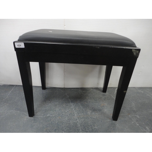 424 - Adjustable ebonised piano stool and a magazine rack.  (2)