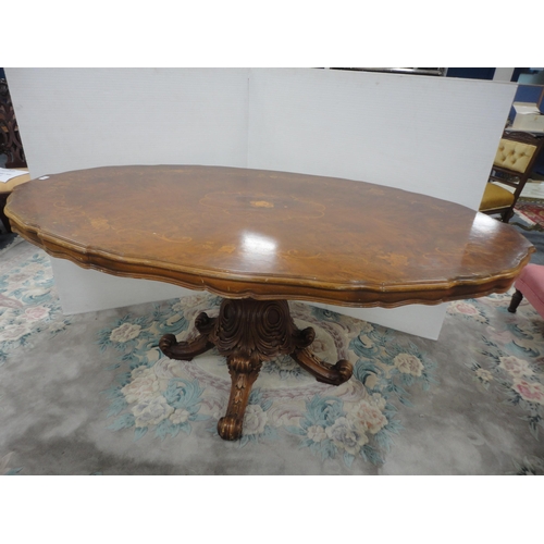 430 - Italian Sorrento-style walnut dining table with scroll inlay to the shaped top, on turned and carved... 