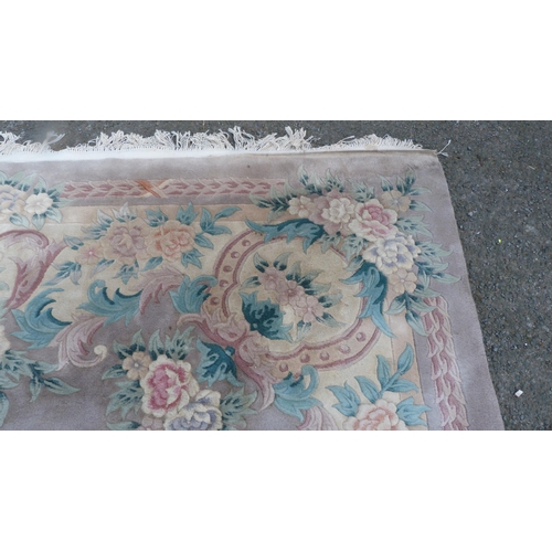 431 - Chinese-style rug on pale ground.