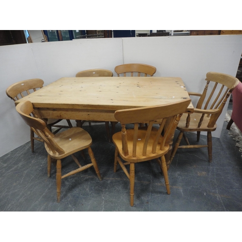 433 - Pine kitchen table and a set of six pine chairs, including one carver.  (7)