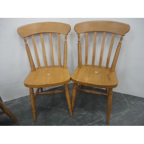 433 - Pine kitchen table and a set of six pine chairs, including one carver.  (7)