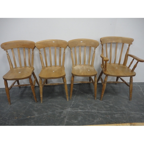 433 - Pine kitchen table and a set of six pine chairs, including one carver.  (7)