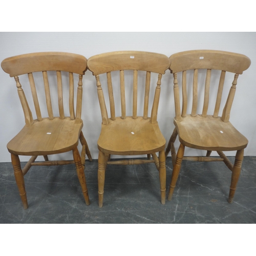 433 - Pine kitchen table and a set of six pine chairs, including one carver.  (7)