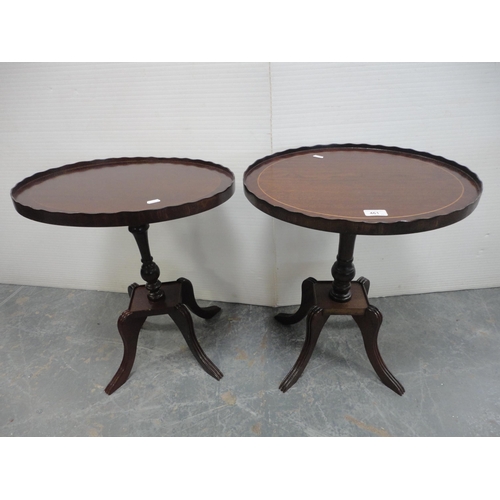 461 - Pair of oval mahogany occasional tables on quadripartite bases.