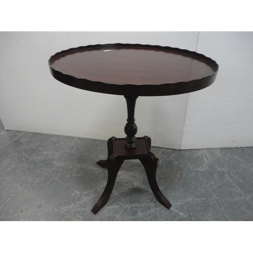 461 - Pair of oval mahogany occasional tables on quadripartite bases.