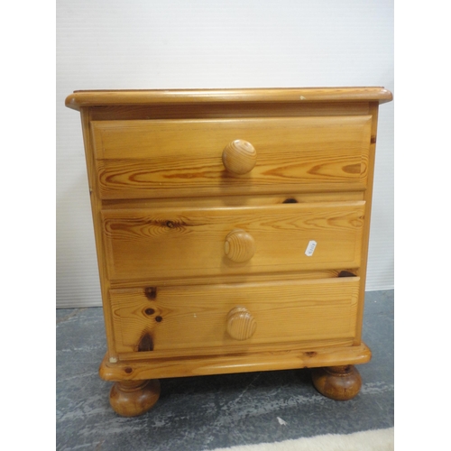 467 - Pine three-drawer bedside chest.