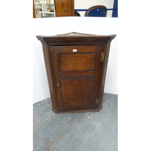 478 - Late 18th century oak corner cupboard with panelled door enclosing shelving, 108cm high, 82cm wide a... 