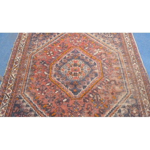 502 - Persian Shiraz hand-knotted rug in Caucasian colours, with geometric medallion to the centre flanked... 