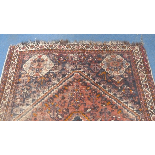 502 - Persian Shiraz hand-knotted rug in Caucasian colours, with geometric medallion to the centre flanked... 