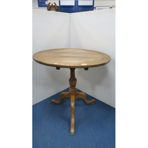 504 - George III style circular oak table with saucer top, on turned column and tripod feet, 77cm high and... 