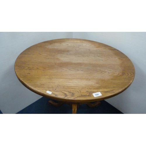 504 - George III style circular oak table with saucer top, on turned column and tripod feet, 77cm high and... 