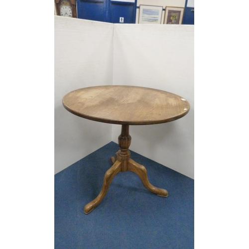 504 - George III style circular oak table with saucer top, on turned column and tripod feet, 77cm high and... 