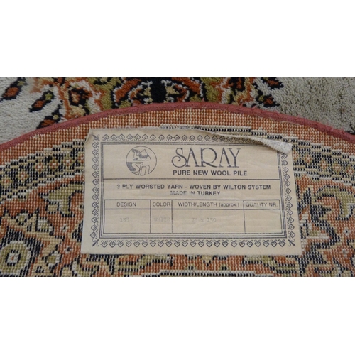 517 - Turkish Saray oval rug, and a similar circular rug,  (2)