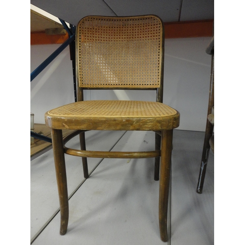 542 - Three matching bentwood bergère cafe chairs, including one carver.  (3)