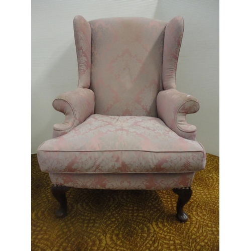 553 - Wing armchair, upholstered in pink damask.