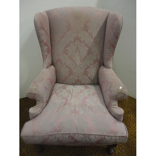 553 - Wing armchair, upholstered in pink damask.