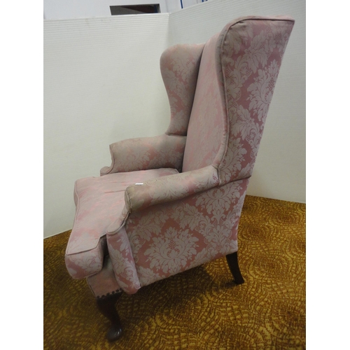 553 - Wing armchair, upholstered in pink damask.