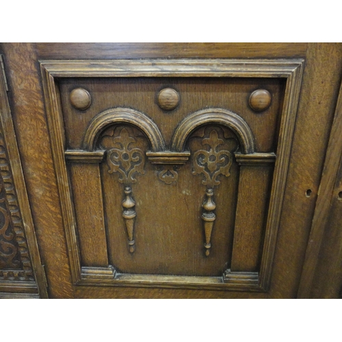 554 - Carved oak two-door sideboard raised on bulbous supports.