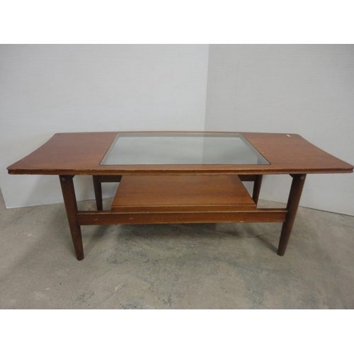 560 - Teak coffee table with glass top.