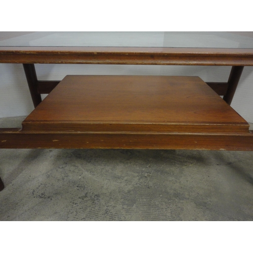 560 - Teak coffee table with glass top.