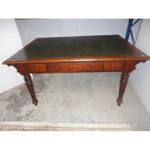 576 - 19th century mahogany library table on turned supports.