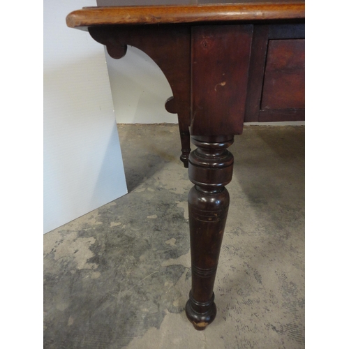 576 - 19th century mahogany library table on turned supports.