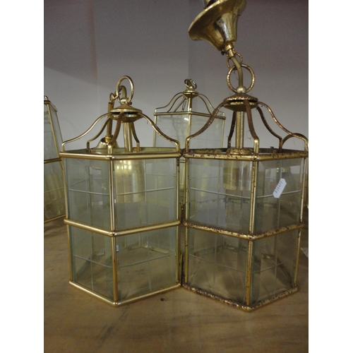 577 - Three near matching brass lantern-style ceiling lights and a three-branch electrolier.  (4)