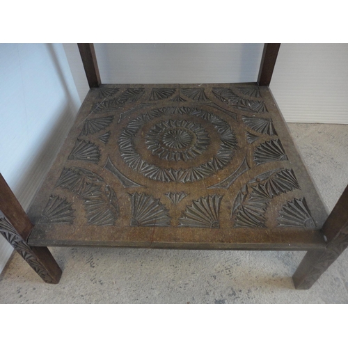 582 - Indian style carved two tier occasional table.