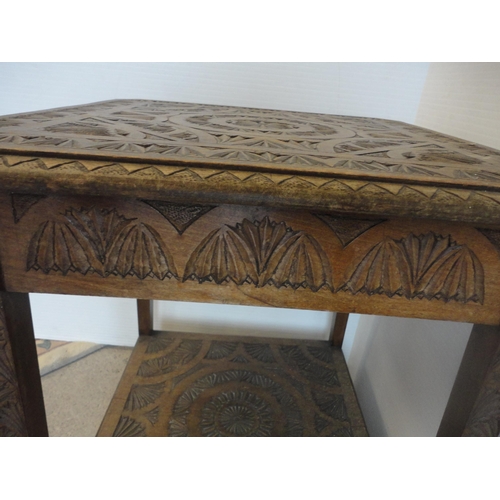 582 - Indian style carved two tier occasional table.