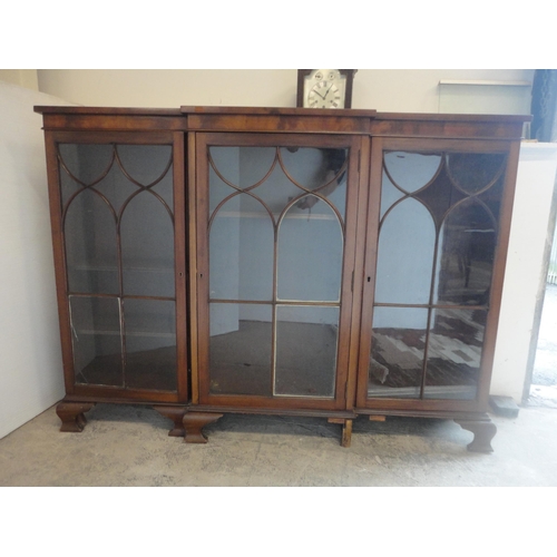 584 - Mahogany breakfront three-door bookcase enclosed by astragal glazed doors.