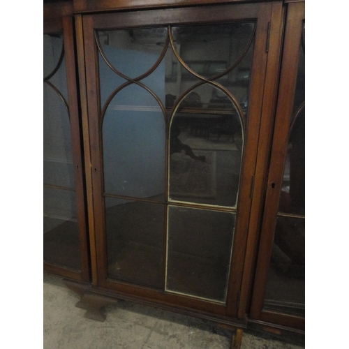 584 - Mahogany breakfront three-door bookcase enclosed by astragal glazed doors.