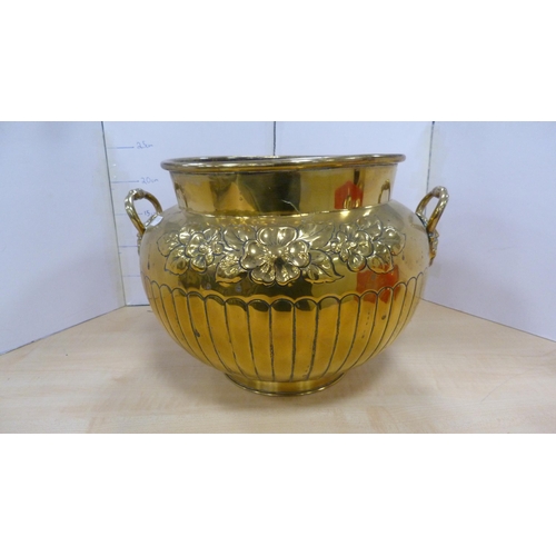 60 - Brass jardinière with mask handles and impressed with foliage, and a brass wall charger.  (2)