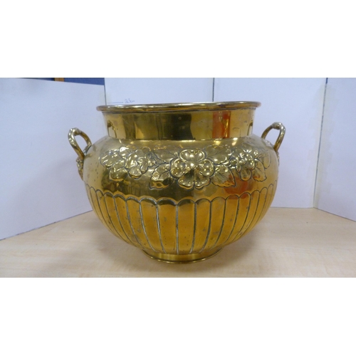 60 - Brass jardinière with mask handles and impressed with foliage, and a brass wall charger.  (2)