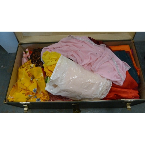 73 - Two trunks containing a large quantity of fabrics to include Middle Eastern-style silks, satins, bea... 