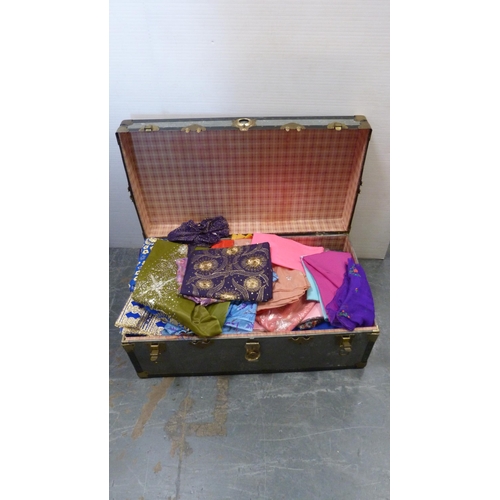 73 - Two trunks containing a large quantity of fabrics to include Middle Eastern-style silks, satins, bea... 