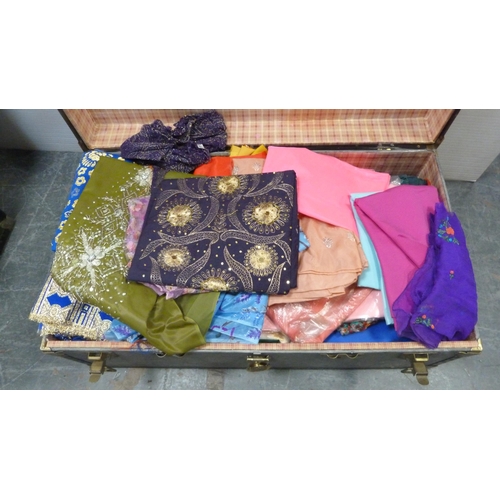 73 - Two trunks containing a large quantity of fabrics to include Middle Eastern-style silks, satins, bea... 