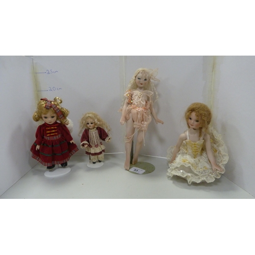 83 - Four bisque china dolls, in assorted dress.  (4)