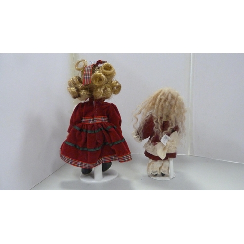 83 - Four bisque china dolls, in assorted dress.  (4)