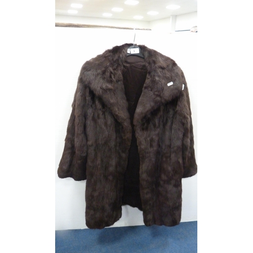 9 - Lady's simulated fur coat, similar hat, and a suede and simulated fur coat.  (3)