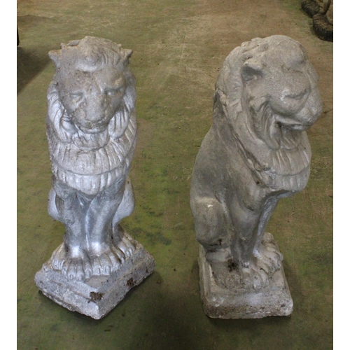 523 - Pair of painted stoneware lions, 55cm tall.