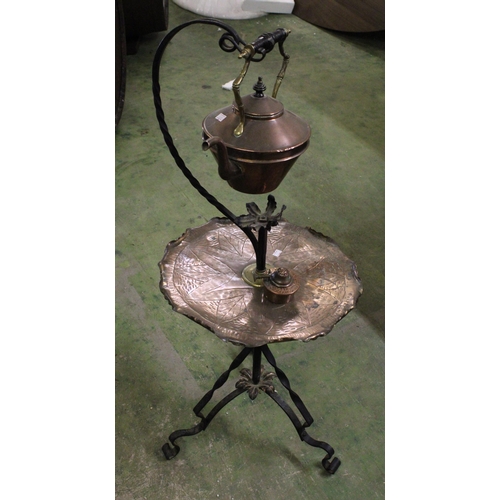 529 - Wrought iron and copper tea warmer with stand on tripod base, 95cm tall.