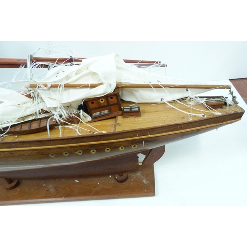 343 - Large scratch-built wooden pond yacht with masts, small boats to the deck, fixed to a plinth stand, ... 