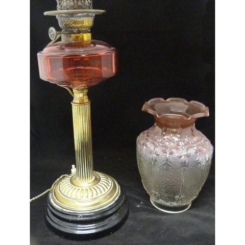 388 - Duplex oil lamp, c. early 20th century, with cranberry glass reservoir, above brass fluted cylindric... 