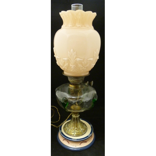 389 - Art Nouveau oil lamp, probably British made, with glass reservoir decorated with stylised green glas... 