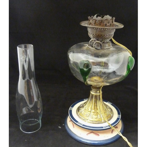 389 - Art Nouveau oil lamp, probably British made, with glass reservoir decorated with stylised green glas... 