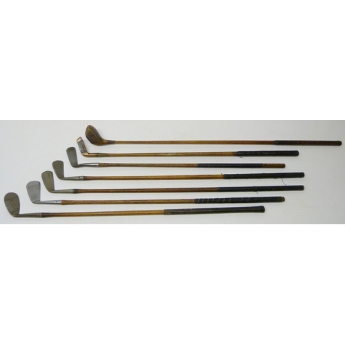 412 - Group of seven antique Scottish hickory-shafted and metal golf clubs to include a long iron, stamped... 